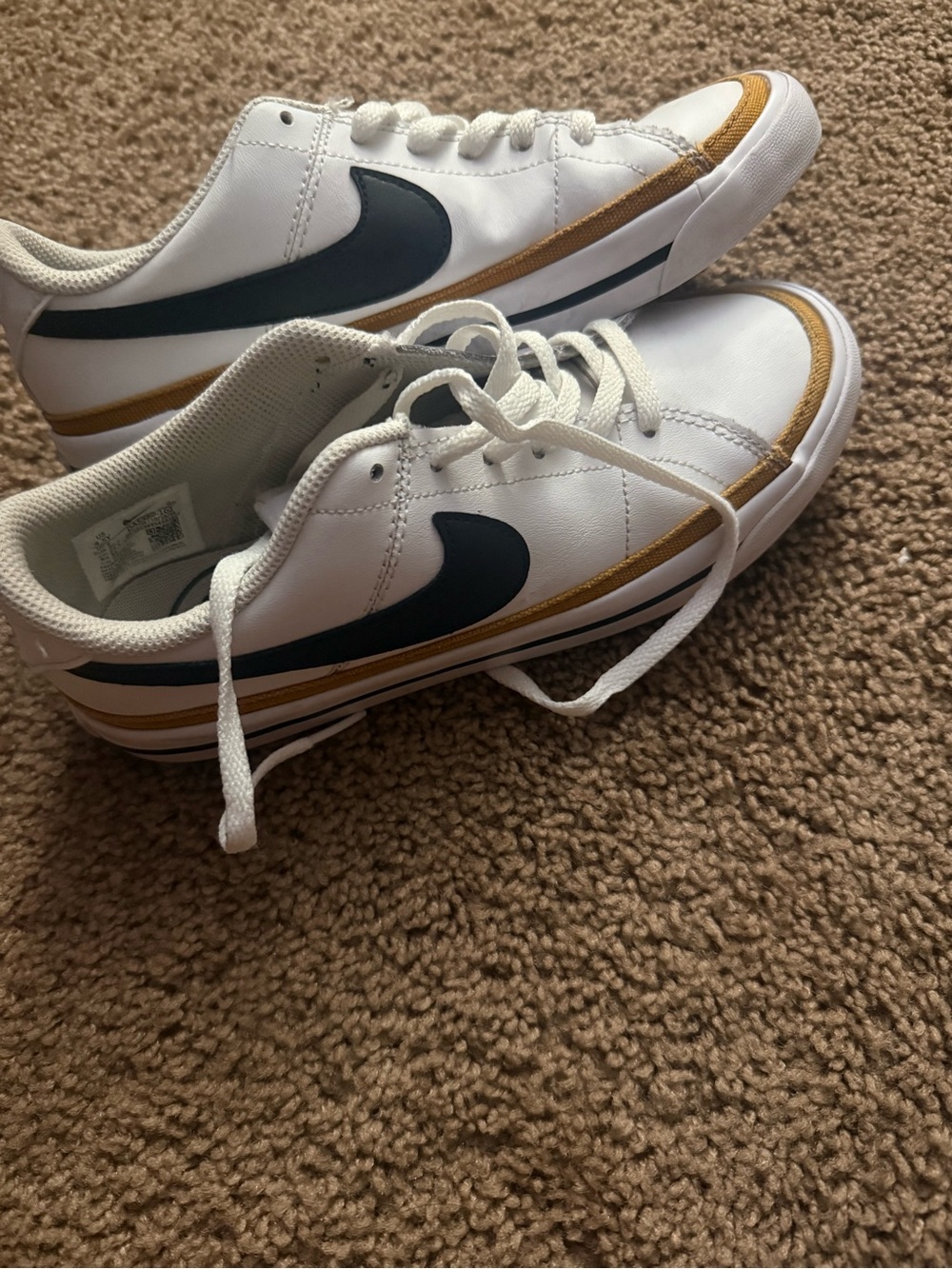 Nike  White Sneakers with Black Swoosh and Gold Accent